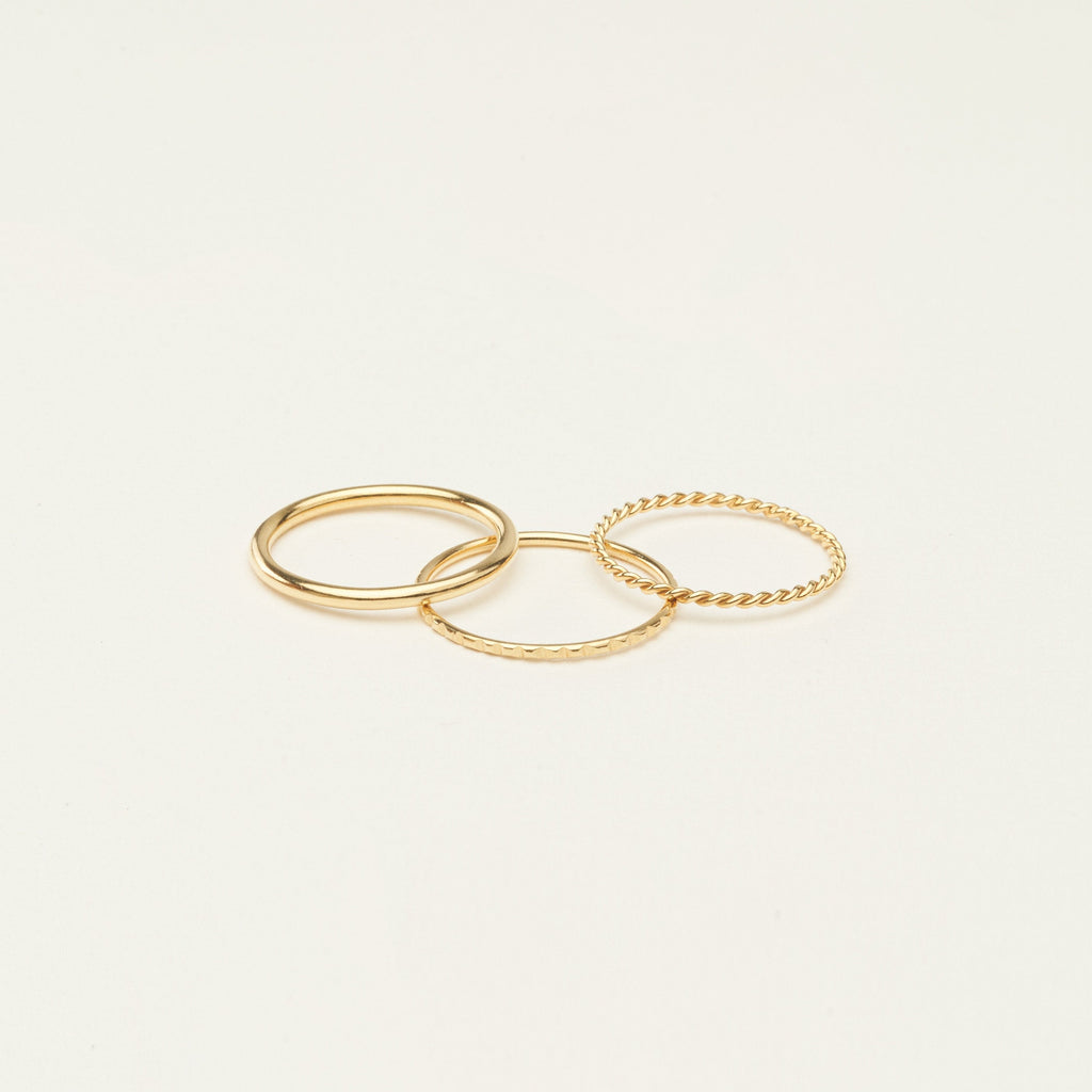 Three sterling silver thin stacking rings with different textures are arranged on a plain, light background—ideal for creating a stylish ring stack or giving as a thoughtful Christmas gift.