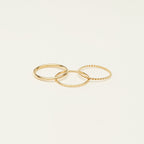 Three sterling silver thin stacking rings with different textures are arranged on a plain, light background—ideal for creating a stylish ring stack or giving as a thoughtful Christmas gift.