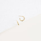 Two Chloe Hoops with polished bands are displayed on a white speckled surface against a minimal background—perfect for everyday wear.