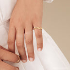A hand wearing the Curb Chain Ring and a gold thumb ring, styled with goth glam jewelry and a white sleeve.