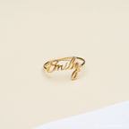 The Grace Script Name Ring features the name Emily in elegant cursive on a cream and white background.