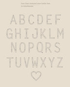 Outlined uppercase alphabet letters and a heart in a minimalist serif font on beige—perfect inspiration for a bold statement piece like the Large Sideways Initial Necklace in Rose Gold.