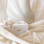 Classic Heart Studs displayed on a white box, with soft fabric and dried plants in the background for a delicate, minimalist look.