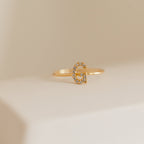 Pave Initial Ring with a letter G set with sparkling gems, showcasing elegant diamond-encrusted initial jewelry. Shown on a light neutral background.