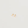 The Tiny Heart Studs in 18K Gold are a perfect gift, featuring delicate heart-shaped gold studs on a white surface—ideal for everyday wear.