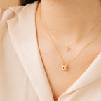 Rae Diamond Necklace with delicate gold chain, small diamond pendant, and gold initial cube charm.