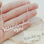 The Handwriting Necklace features a silver pendant engraved in cursive with "With All my love, Mom," making it a sentimental gift for meaningful moments.